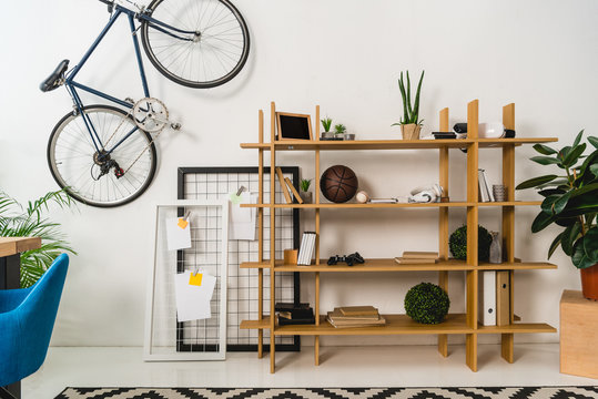 bike on wall and shelves with stuff at home