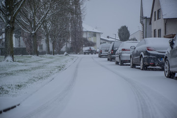 cars parked on the street covered with fresh snow, Germany , Hesse 2017