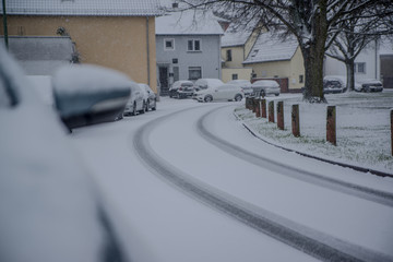 cars parked on the street covered with fresh snow, Germany , Hesse 2017
