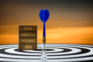 Goal, mission and possible in 2018 concept, dart on board with sunset background .