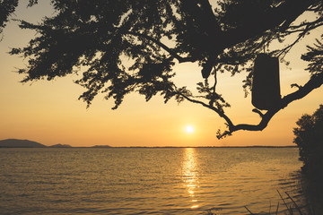Sea and sunset on background