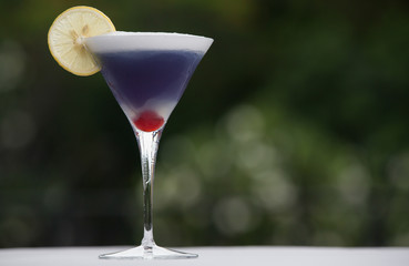 Ultra violet martini cocktail on wooden table