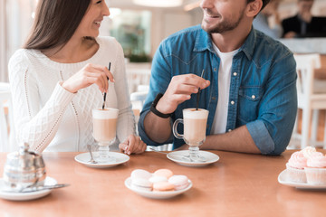 A guy and a girl are sitting together in a cafe.