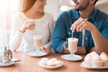 A guy and a girl are sitting together in a cafe.