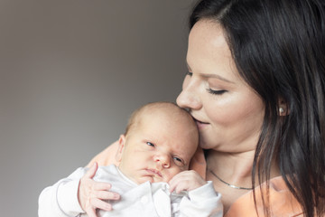 preety woman in her arms is holding and loving her newly born child