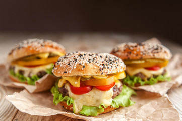 delicious juicy home burger. roll, bagel, with a juicy cutlet from beef, sauces cheese fresh lettuce leaves