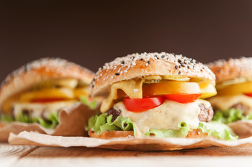 delicious juicy home burger. roll, bagel, with a juicy cutlet from beef, sauces cheese fresh lettuce leaves