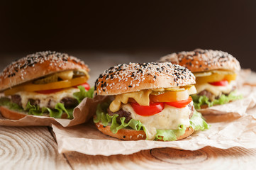 delicious juicy home burger. roll, bagel, with a juicy cutlet from beef, sauces cheese fresh lettuce leaves