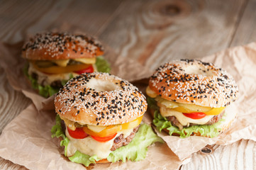 delicious juicy home burger. roll, bagel, with a juicy cutlet from beef, sauces cheese fresh lettuce leaves