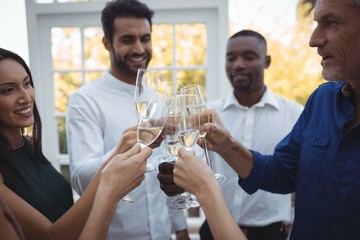 Friends toasting champagne glasses in restaurant