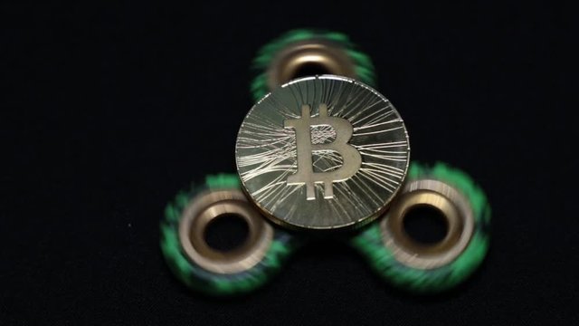 Coin bitcoin and toy spinner.