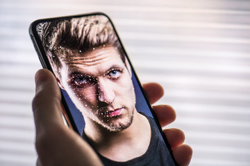 A smartphone using face ID recognition system.