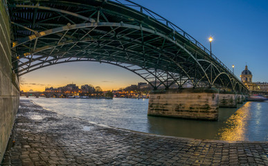 Fototapeta na wymiar River Seine with Pont des Arts and Institut de France at sunrise in Paris