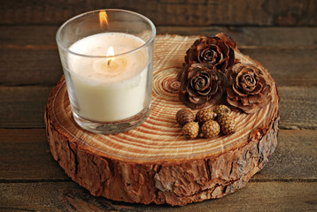 White candle lit on wood
