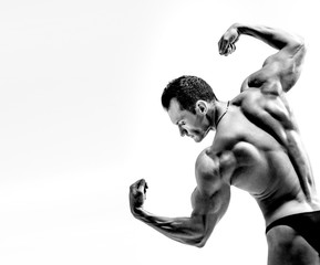 athletic guy - bodybuilder,  pose on white background