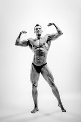 athletic guy - bodybuilder,  pose on white background