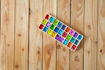 Colorful English letters in the wood boxes for decoration wording as a new year, Christmas on wooden background.
