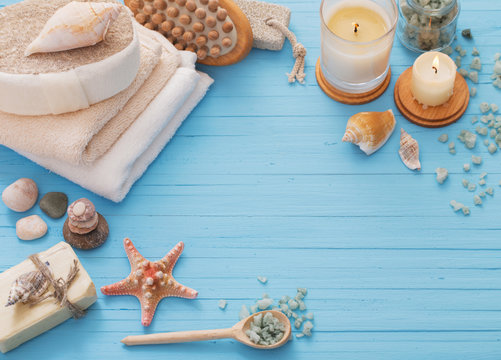 Spa concept with candles on blue wooden background