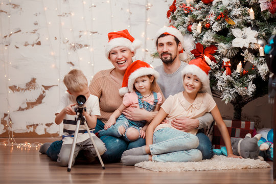 New Year's photo of parents, two daughters and son with telescope