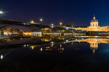 Fototapeta na wymiar River Seine with Pont des Arts and Institut de France at night in Paris