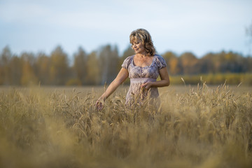 mature woman in wheat field