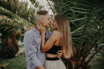 Young Sweet Couple in Tropical Nature. Two beautiful Hipsters Couple in Love. The Guy and the Girl Have Fun at Valentines Day. Film Effects, Toning and Color