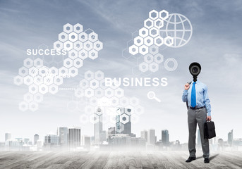 Camera headed man standing on wooden floor against modern cityscape
