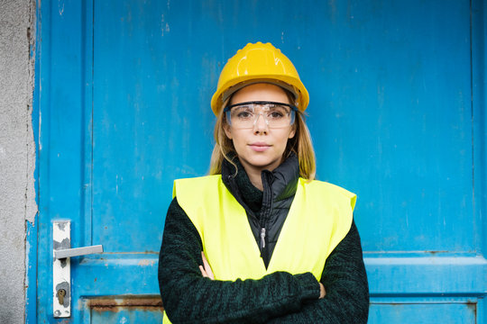 Woman worker standing outside a warehouse.