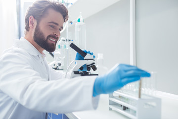 Positive smart biologist taking a test tube