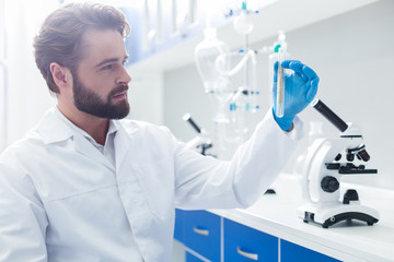 Positive smart biologist taking a test tube