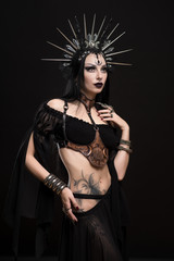 Woman in gothic suit and silver crown