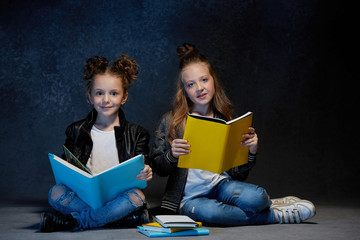 Two kids reading the books at studio