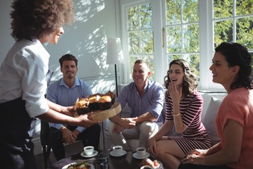 Waitress serving sweet food to customers