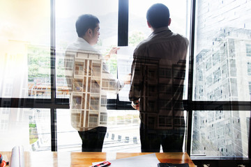 Engineering team consulting and analyzing the high-rise building projects in the city. © weerachai