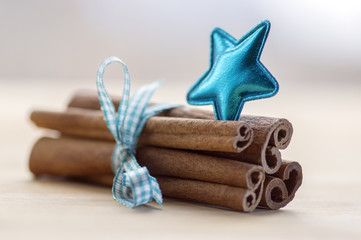 Group of cinnamon tied with checkered light blue bow, blue star