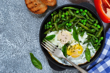 Homemade light breakfast. Scrambled eggs with asparagus and green peas. Crispy baguette grill.