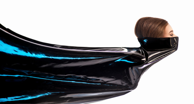 Woman in latex dress on the white background