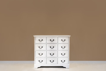 The white color dresser with many drawers
