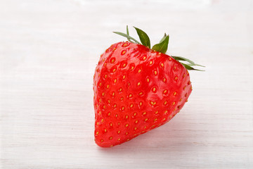 Strawberry on a light wooden background. Fresh sweet strawberry on light wooden background. Red strawberry