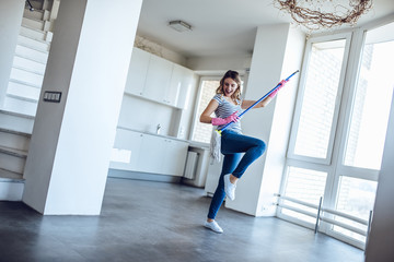 Young woman is doing cleaning at home