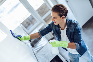 Young man is doing cleaning at home