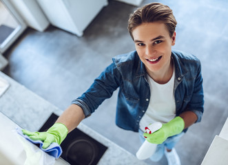 Young man is doing cleaning at home