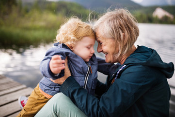 Senior woman with little boy at the lake.