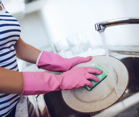 Young woman is doing cleaning at home