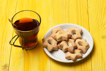 Composition of cup and tiny gateau for tea time.