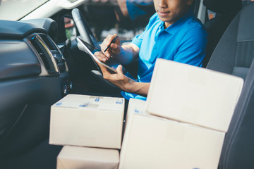 Young Delivery Man Checking Customer List On Tablet.