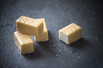 Milk souffle in caramel chocolate on a dark background. 