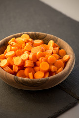 Carrot slices in wooden bowl.