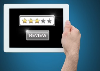 Hands holding tablet with review star ratings