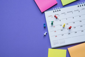 close up of calendar on the purple background, planning for business meeting or travel planning concept